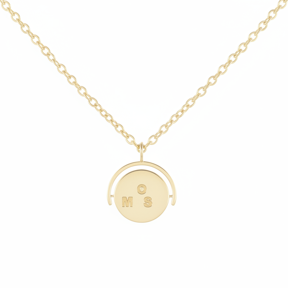 Gold necklace with a round pendant on a white background