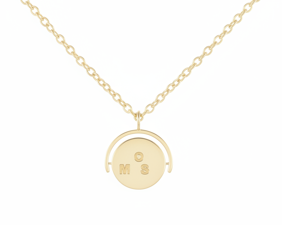 Gold necklace with a round pendant on a white background