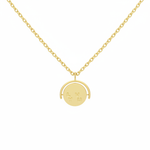 Gold necklace with a round pendant on a white background