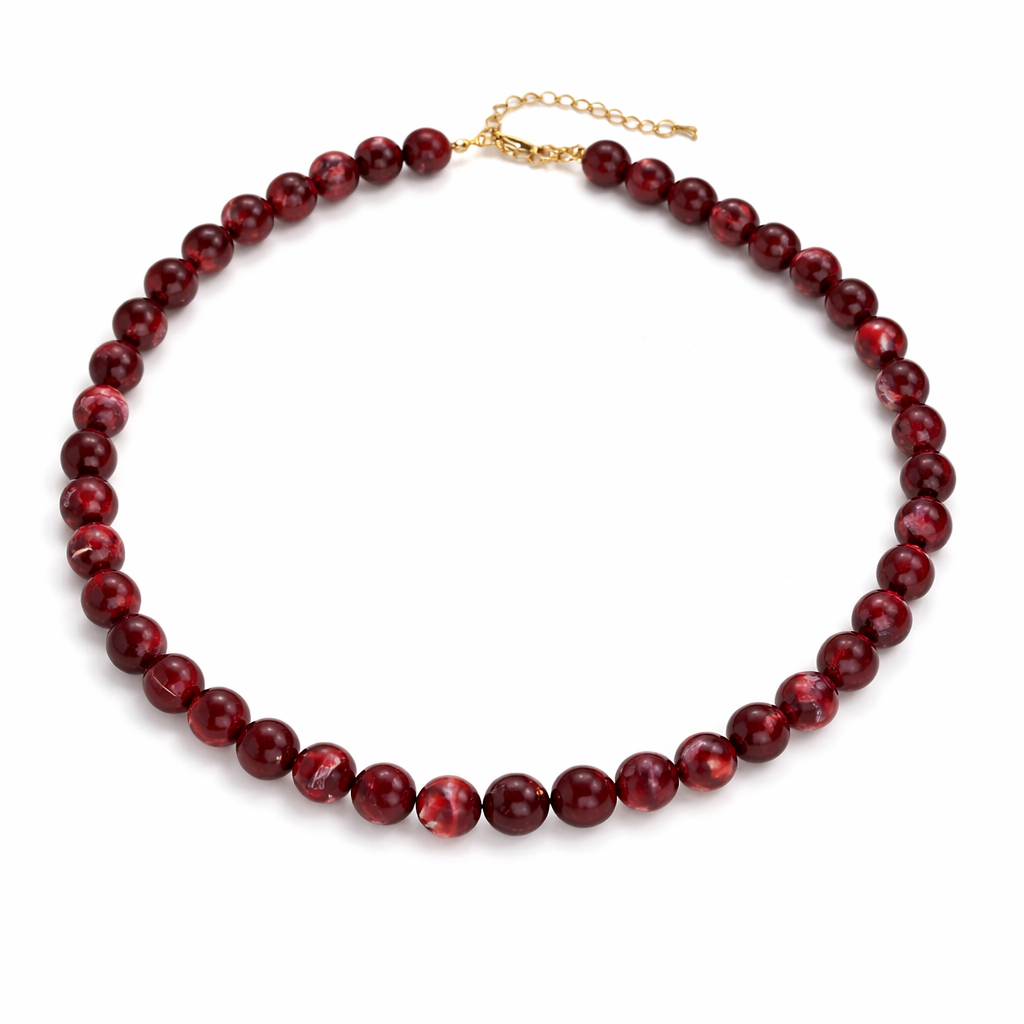 Red beaded necklace on a white background