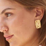 Model wearing gold Bixby earrings 